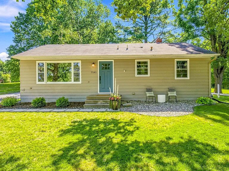 Welcome home to 7141 Minnewashta Pkwy! Charming ranch-style home with cozy patio seating with beautiful lake view, and a spacious, tree-lined backyard