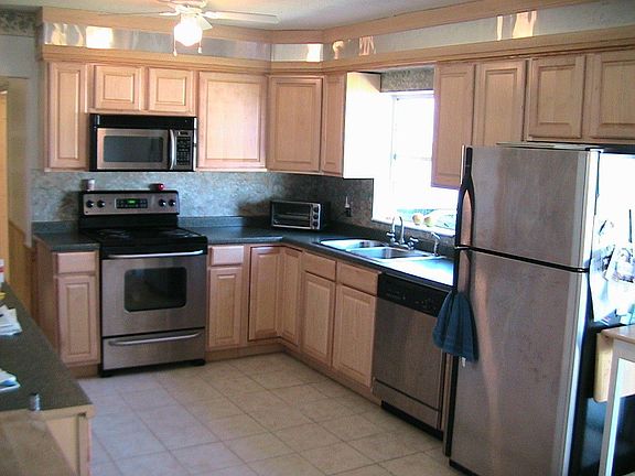 Kitchen with new cabinets, stainless steel appliances, and new tile floors