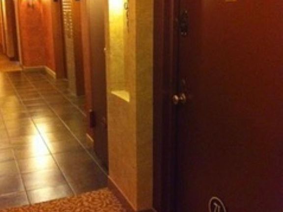 Photo of building hallway leading to apts . Garage disposal room located on every level of 8 story building.