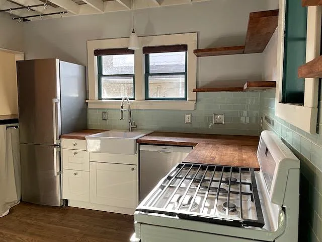 Awesome wood counters with open shelving and apron front sink