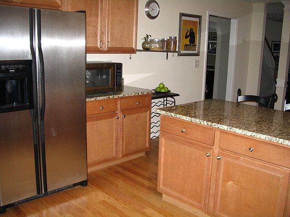 Kitchen With Island, Stainless Appliances Hardwood Floors and Walk-In Pantry
