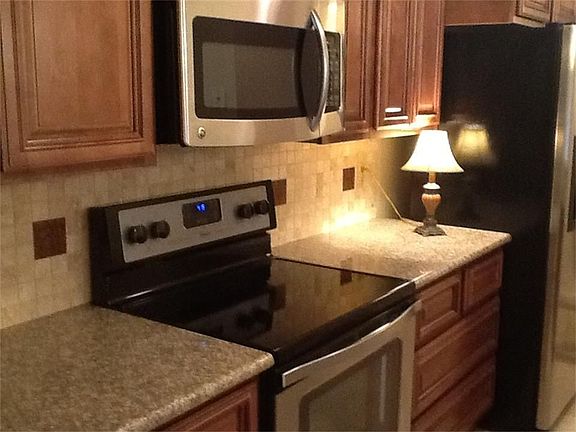 TOTALLY UPDATED kitchen with stainless appliances, including refrigerator and NEW kitchen cabinets.