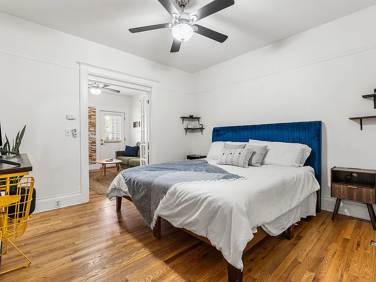 Spacious bedroom with hardwood floors and ample closet space (photographed with a king-size bed).