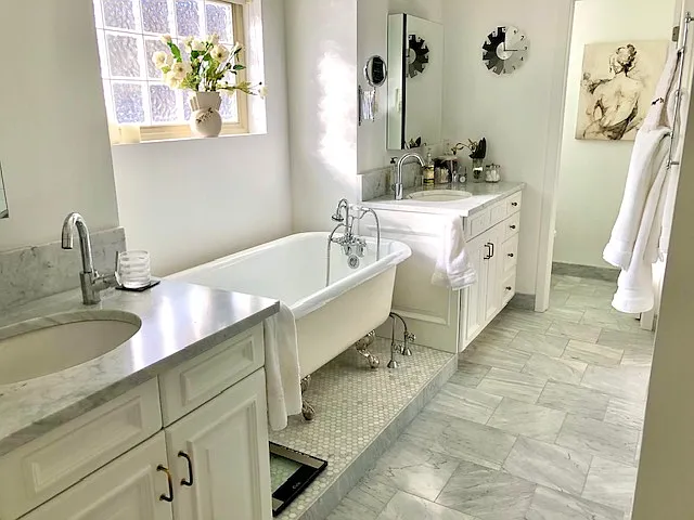 Master bath with separate sinks, a claw-foot tub and stand-alone shower with glass doors. There is a separate toilet room.