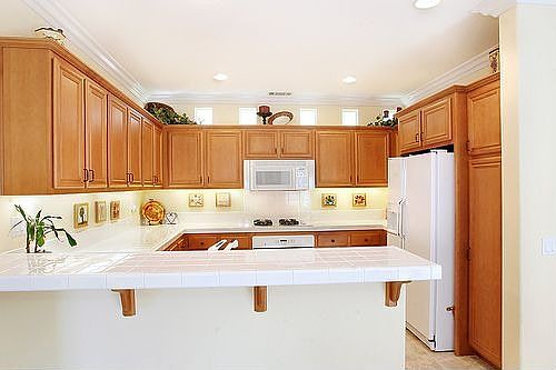 Enormous kitche with maple cabinets.