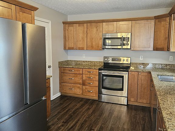 Kitchen with newer appliances and granite countertops