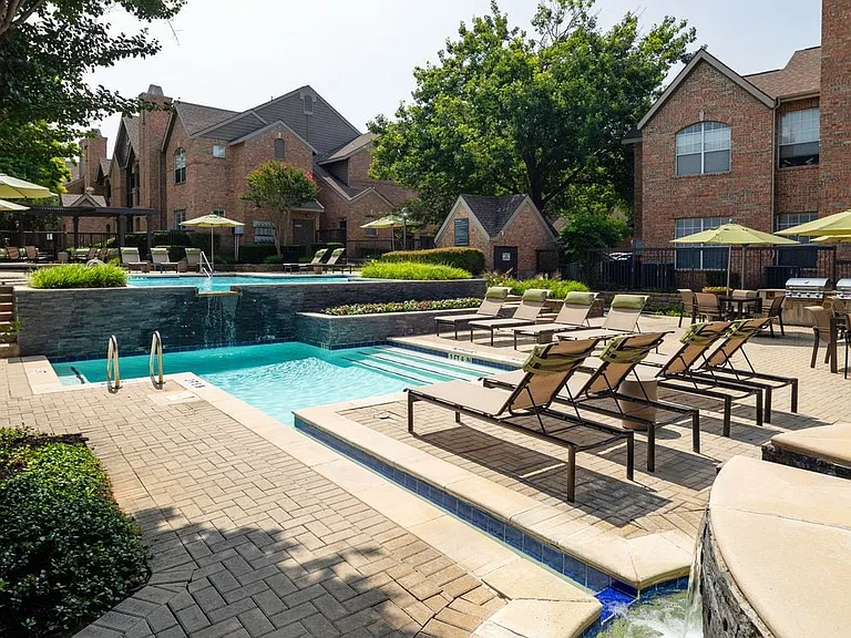 Swimming pool and sundeck with picnic tables