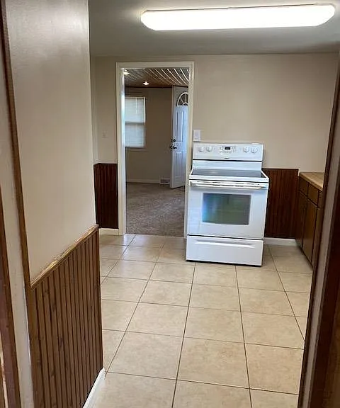 View of Kitchen into Living Room. There is room to put a small table and chairs in kitchen to the left of the brand new stove.