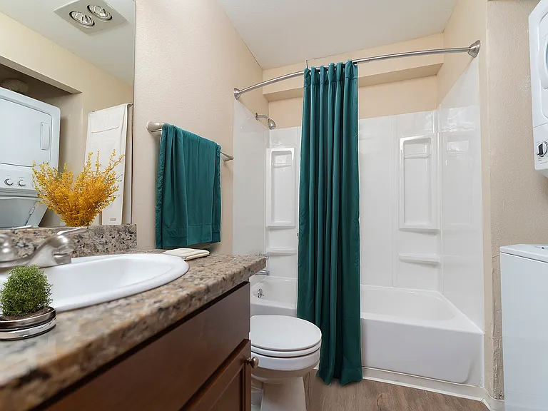 Experience the convenience of a stylish bathroom with integrated laundry features.