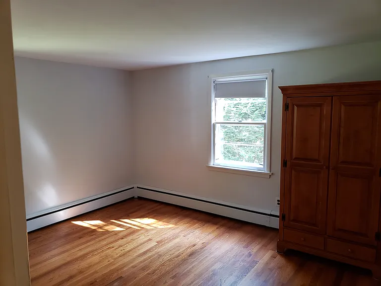 Main bedroom (armoir no longer present). there is a built-in closet in foreground on the left that cannot be seen in this photo.
