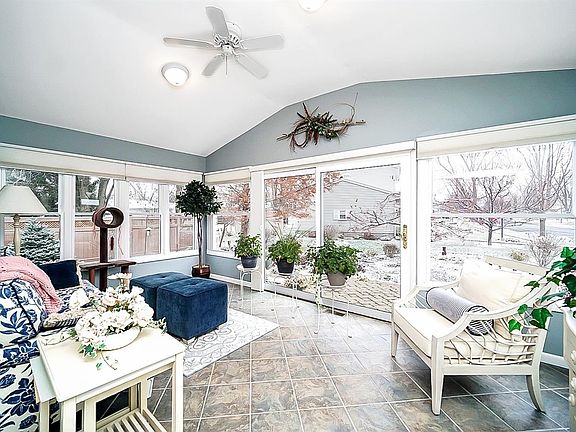 The picturesque sun room was a great addition to the home with 3 walls of windows and sliding door, which bring in the natural light and oversee the professionally landscaped yard and patio.