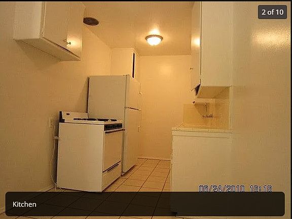 Dated photo of kitchen - it will be painted and it has a newer fridge