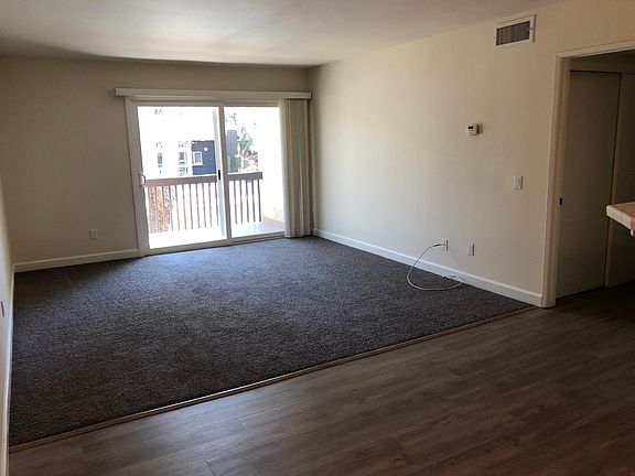 Dining room and living room, with balcony! New flooring.