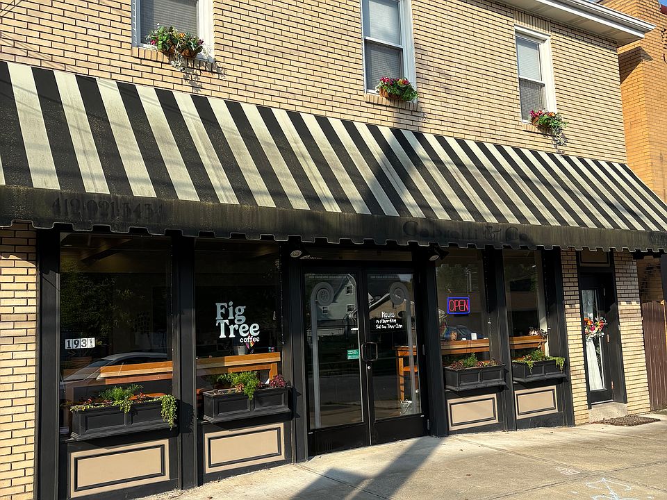Front of the building showing Fig Tree Coffee. There is an entrance to the unit on the right.