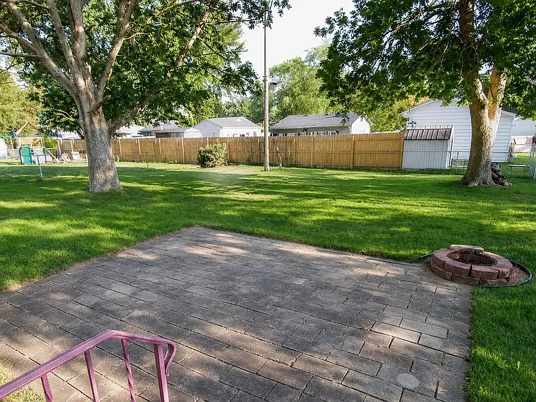 Large, fenced backyard, with mature trees for shade