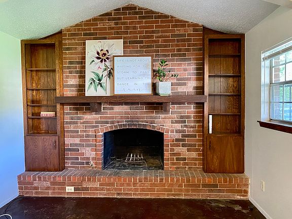 One end of open living has built in bookcases.