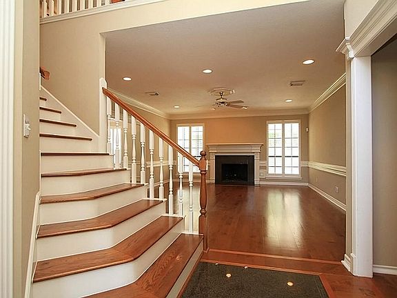 Entry with Granite inlay and wood stairs welcome you.