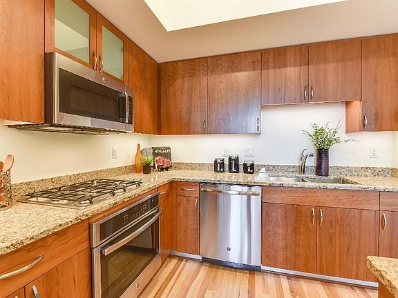 Deep Sink, Stainless Steel Dishwasher, Microwave with Vent Hood.