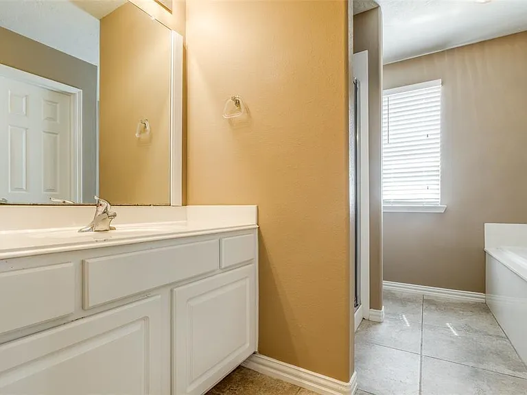 The en-suite bathroom includes large walk-in closet, shower, and oval soaker tub.