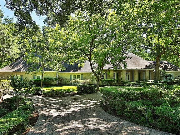 Stunning front elevation with lush landscape, oversized 3-car garage to the left, circular drive and single side drive providing plenty of guest parking.