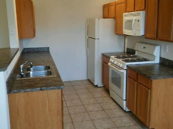 Refrigerator, range and dishwasher included.