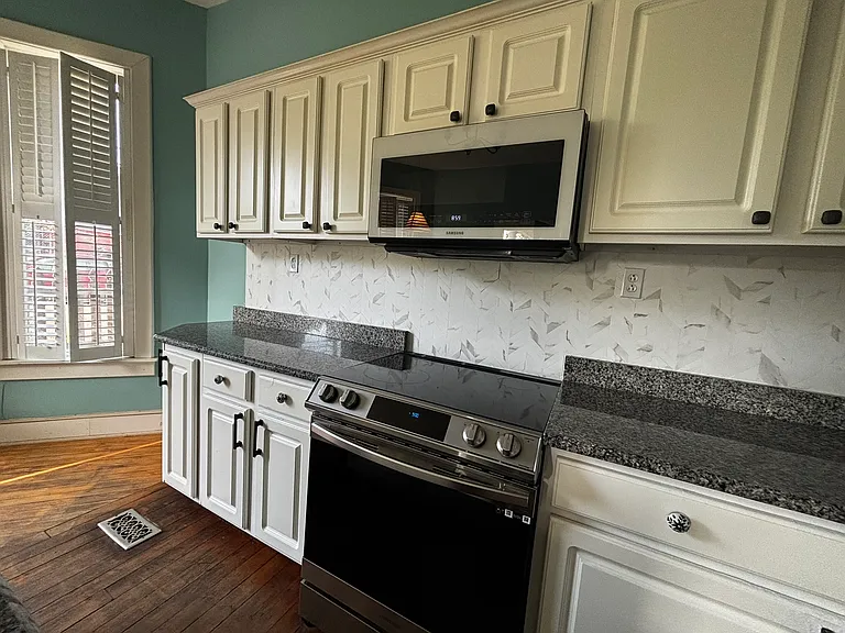 Kitchen is extra large with room for dining table and desk, sitting or play area.