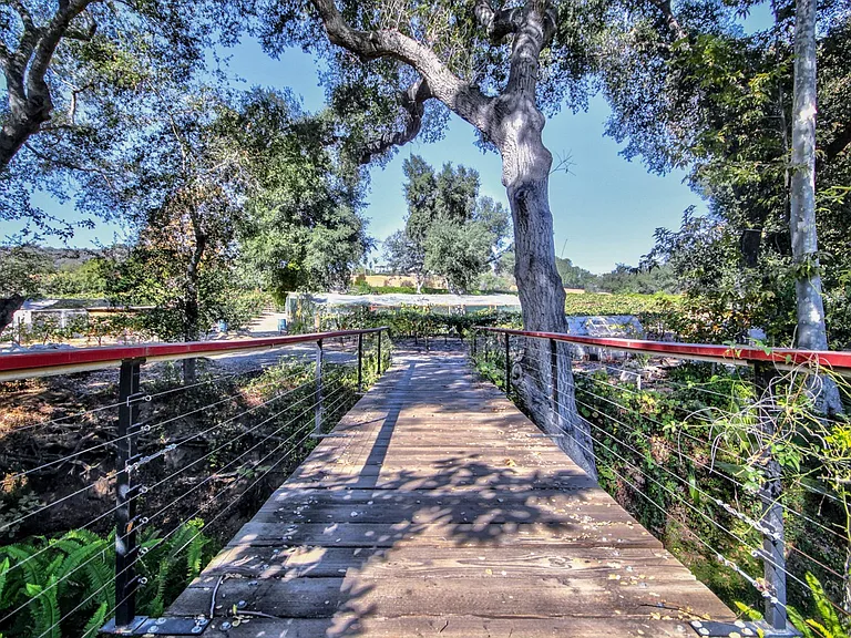 bridge over river to vinyard and gardens