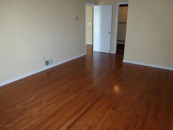 Hardwood flows into master bedroom