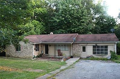 Exterior Front. Brick and siding exterior. Concrete walk ways. Black top driveway. Mini garden at the entrance