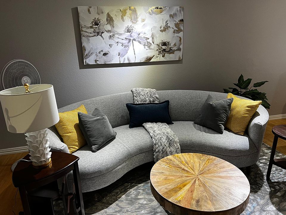 Living room area includes 8-foot couch for family to enjoy surround sound TV system.