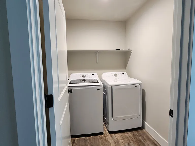 Separate laundry area with shelf.