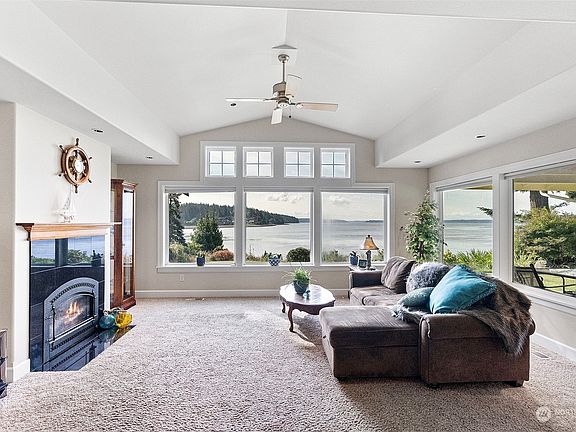 Upon entry you are greeted by beautiful wood-wrapped picture windows.  Enjoy the best of the Northwest with expansive water views.>