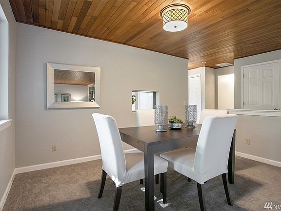 Formal dining room with pass through window into the kitchen for both conversation and serving.