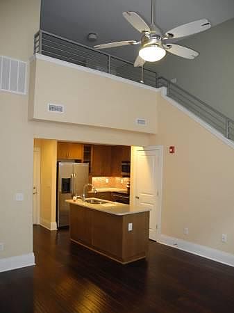 Living room looking into kitchen and stairway to sleeping le