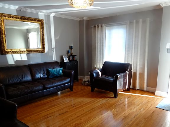 Large Living Room with Hardwood Floors, Crown Moldings