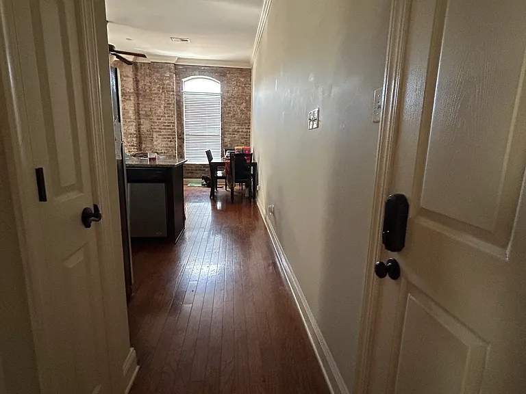 Hallway going into kitchen/dining/living area. The main entry door is on the right in this photo.