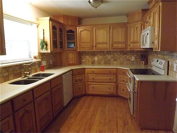 Solid hickory cabinets with under counter lighting are just gorgeous! Notice the oversized 3 compartment sink and the tile back splash!