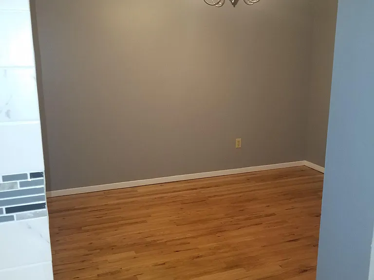 Dining Room on Level 1 with Ceiling Chandelier , wooden floor