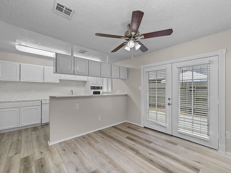 Apartment dining room and kitchen at Mango Tree Apartments in Santa Ana, CA