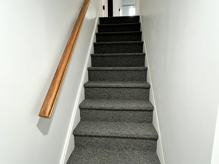 Stairs to bonus room with new carpet