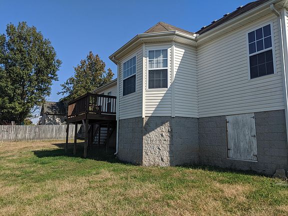 Rear of the house shows the privacy fence and deck.