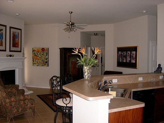 Living room with cast stone fireplace.