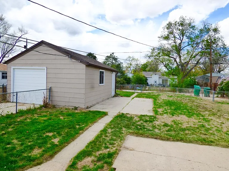 Rear yard, patio, and view of off alley parking spot.