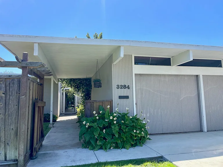 Entry way from front lawn with the gate and door open
