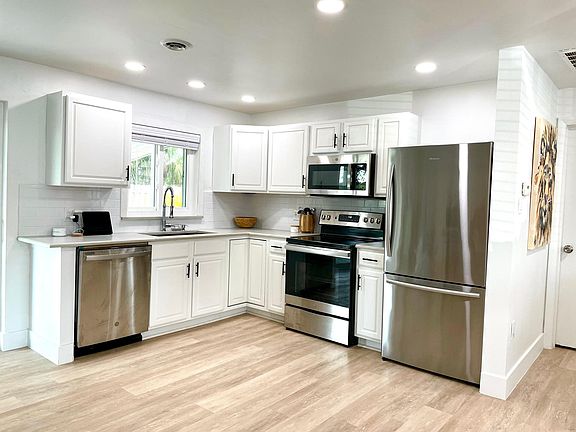 Beautiful new kitchen with stainless steel appliances and real stone quartzite countertops.