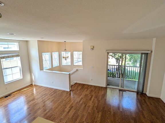 Open living/dining area with balcony