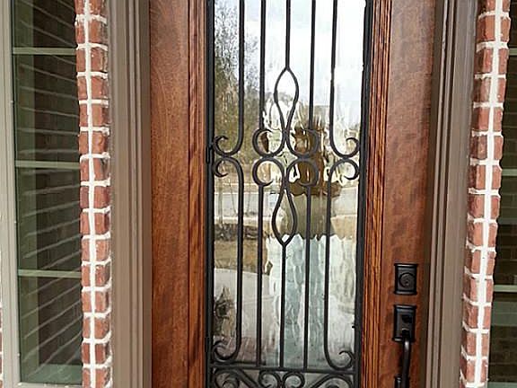 Beautiful Mahogany front door with full size wrought iron and glass window!