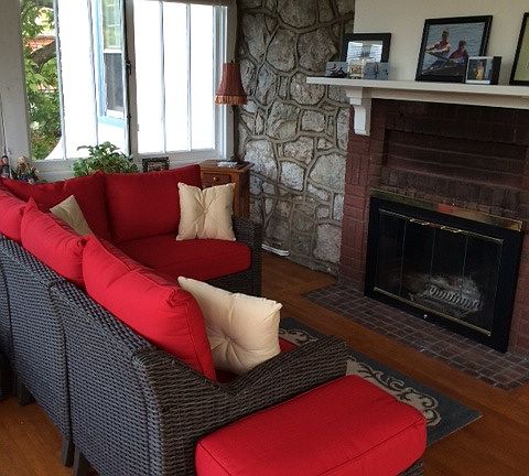 sunroom with wood burning fireplace