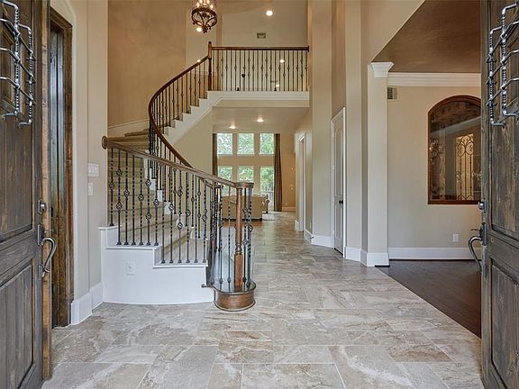 These gorgeous double doors open to a stunning foyer and grand staircase.