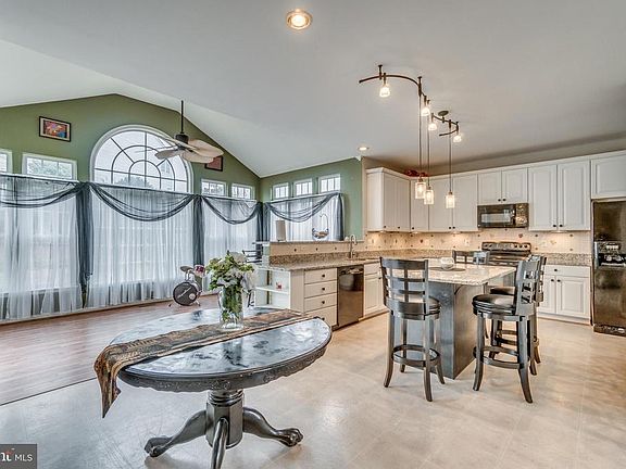 Large Sunroom with Fan off Kitchen